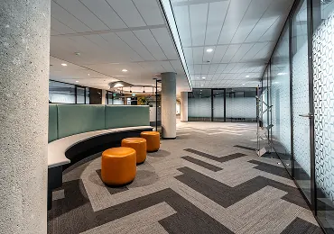 Office architecture with curved seating and patterned carpet tiles