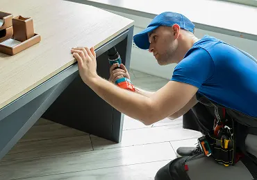 Installer assembling an office desk