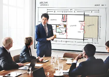 Project manager presenting an office floor plan to a client team
