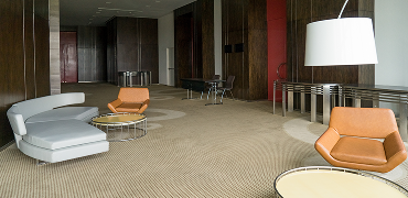 Office lounge with parquet flooring and designer seating