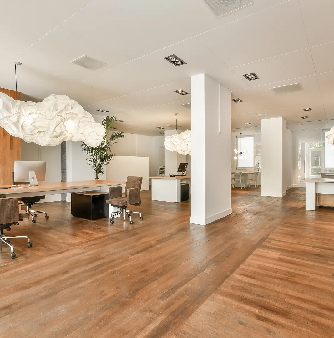 Open office with wood flooring and modern workstations