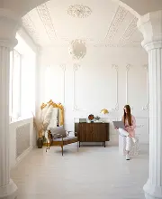 Classic white villa interior with columns and ceiling mouldings in Dubai