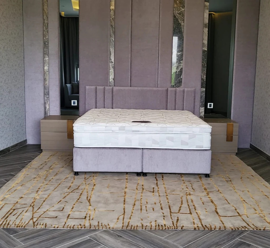 Bedroom with custom hand-tufted carpet and upholstered headboard in Dubai