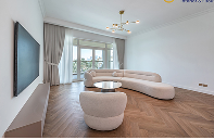 Bright living room with herringbone wood flooring in a Dubai villa